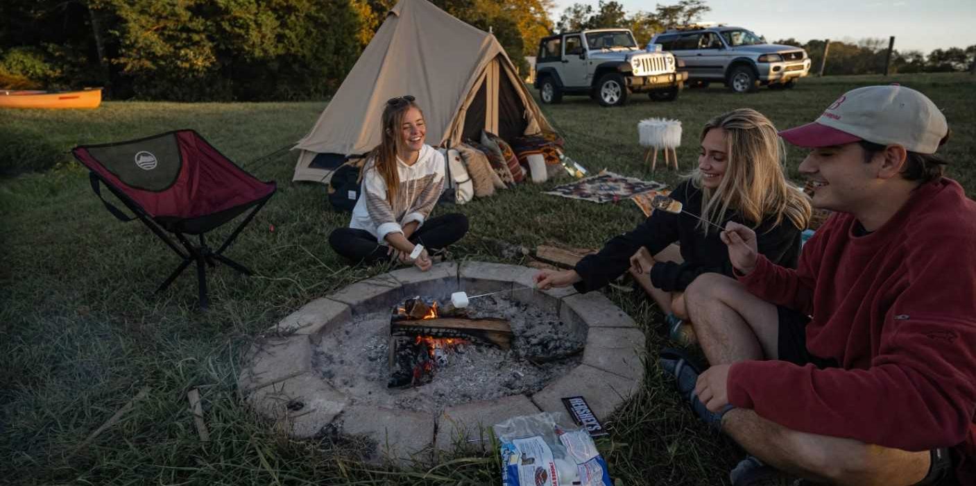 friends enjoying marshmallow on campfire